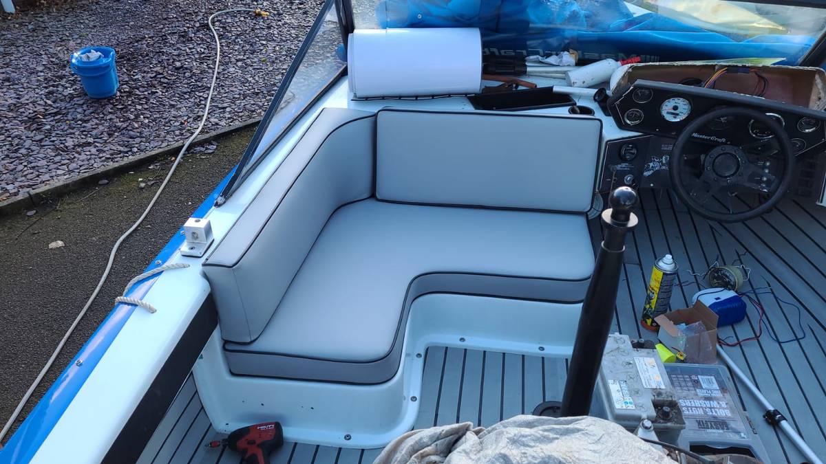 MasterCraft cockpit with fully reupholstered L-shaped seating in grey marine vinyl
