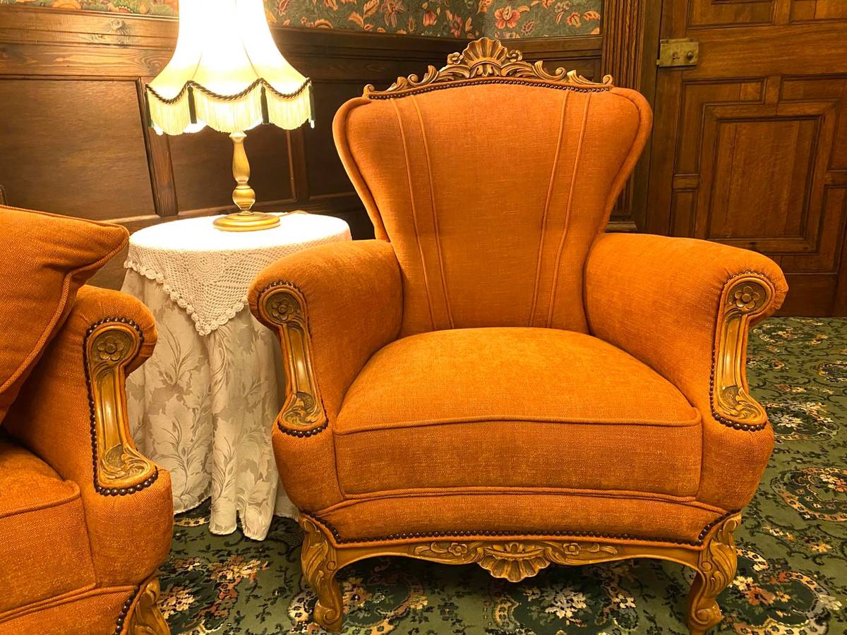 French rococo armchair with carved arms and nailhead trim