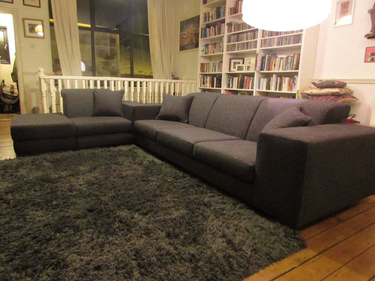 Reupholstered L-shaped sectional sofa in dark charcoal fabric