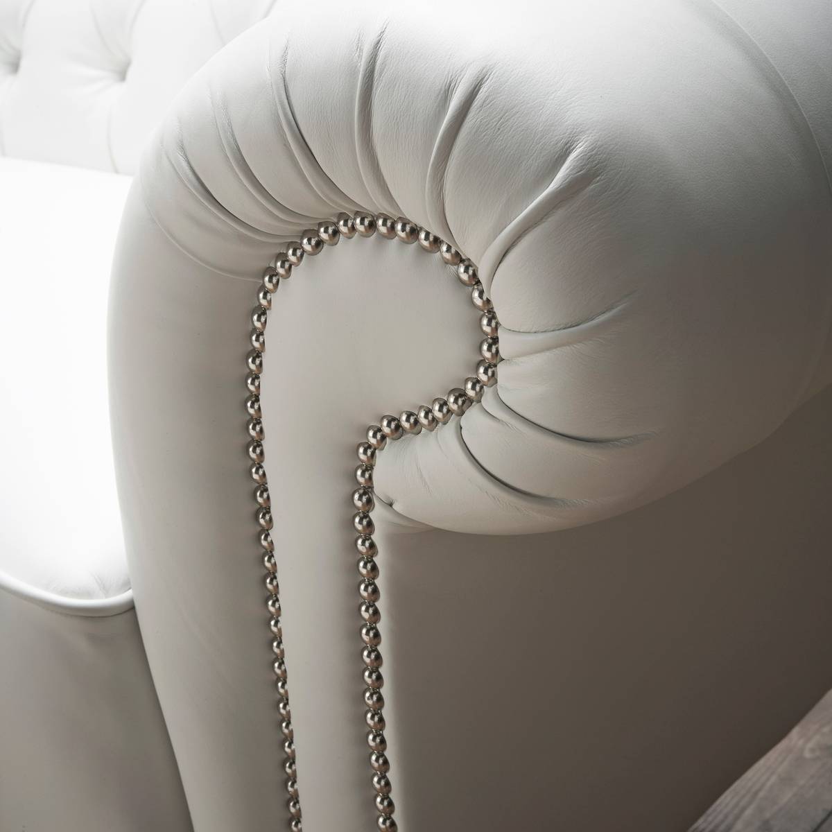 Arm roll detail with nailhead trim